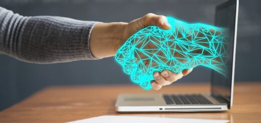 Image of handshaking cyber hand extending from computer screen